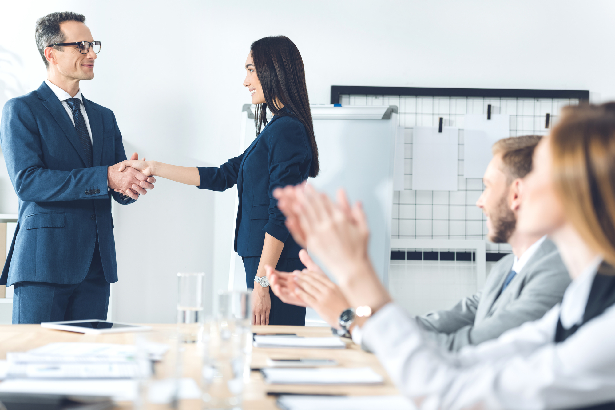 Boss shaking hand of manageress