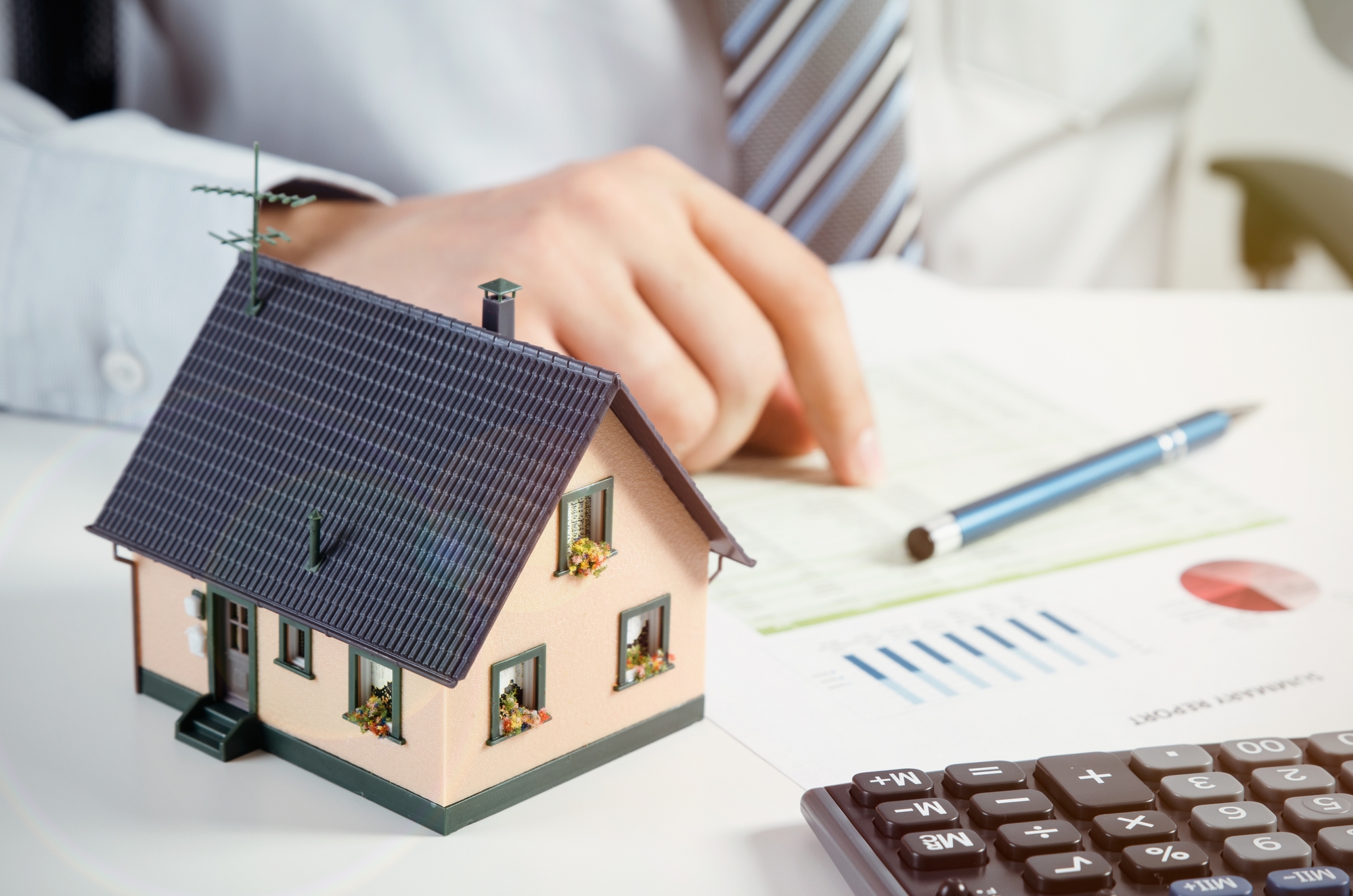 Businessman calculate the cost of building and maintaining home