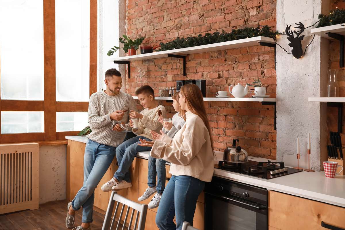 Happy family resting together in kitchen (R) (S)