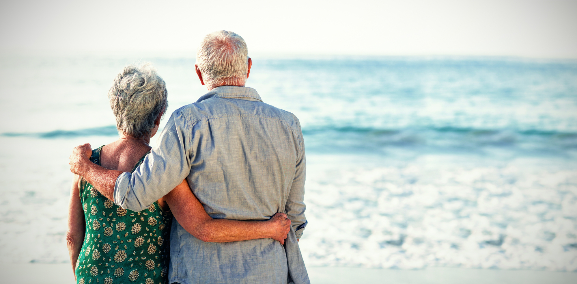 Senior couple at beach against sea